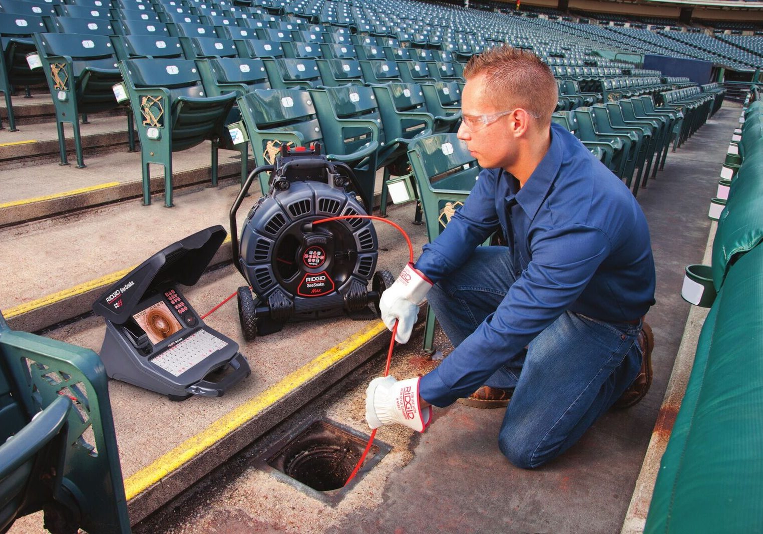 image of man checking down a drain